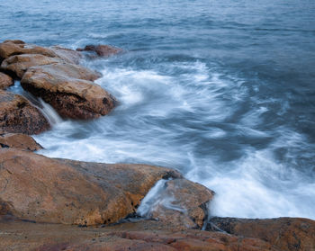 Scenic view of rocks at sea shore