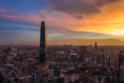 Aerial view of modern buildings against sky during sunset