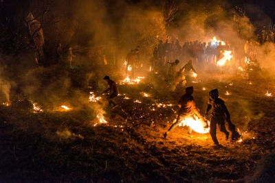 Group of people in fire at night