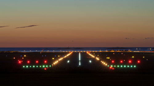 Illuminated lights against sky at night