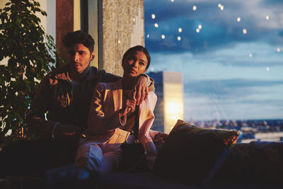 Young couple sitting outdoors