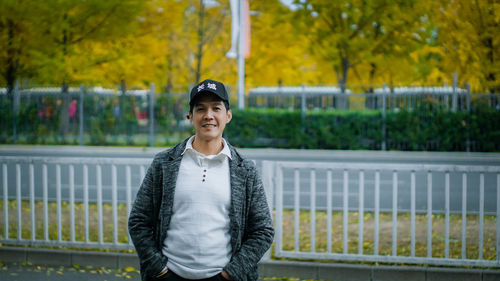 Portrait of young man standing outdoors