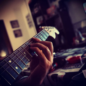 Close-up of man playing guitar