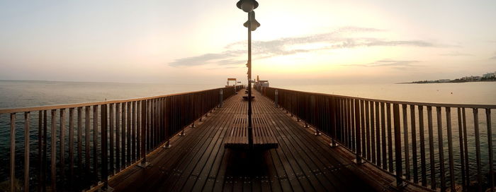 Wooden pier in protaras in cyprus at sunrise