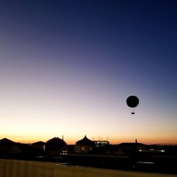 Silhouette of hot air balloon against sky at sunset