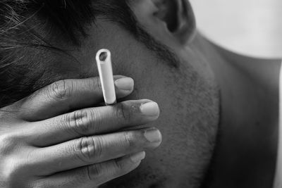 Midsection of tensed man smoking cigarette