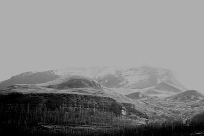 Scenic view of mountains against cloudy sky