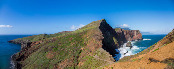 Panoramic view of sea against blue sky