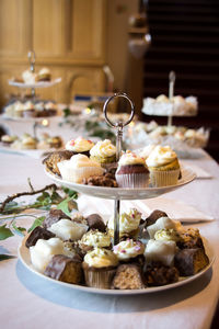 Cup cakes on stand at table