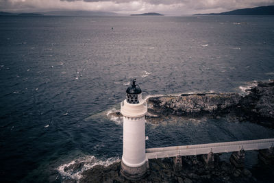 High angle view of lighthouse by sea against sky