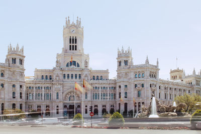 Buildings in city against clear sky during sunny day