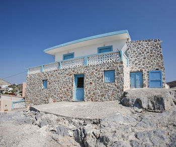 Buildings against clear blue sky