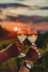 Midsection of person holding wine glass