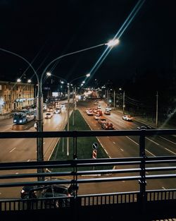 Light trails on bridge in city at night