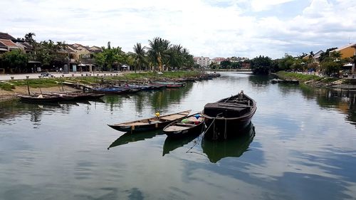 Boat moored in lake against sky