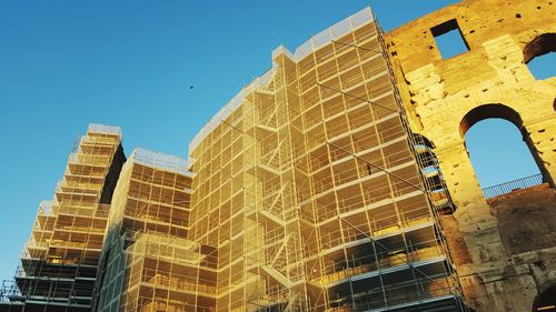 Low angle view of buildings against blue sky