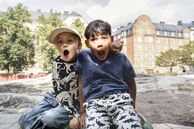 Child friends making faces in park