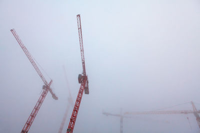 Construction with cranes in the foggy morning