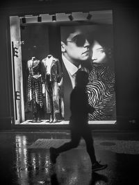 Side view of young man looking away at home