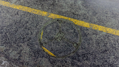 High angle view of yellow road sign on street