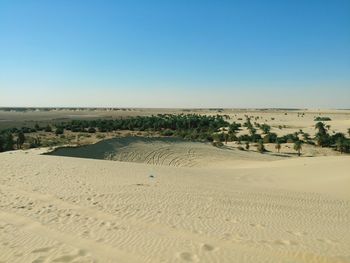 Scenic view of desert against clear blue sky