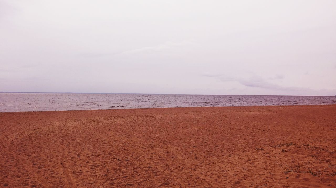 horizon over water, beach, sea, sand, shore, tranquil scene, water, tranquility, scenics, sky, beauty in nature, nature, idyllic, copy space, coastline, remote, wave, calm, day, outdoors