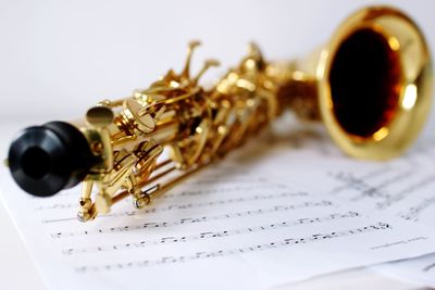Close-up of saxophone on sheet music