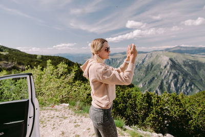 Full length of man standing on mountain against sky