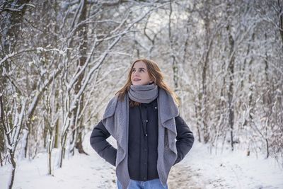 Young woman standing on snow covered land