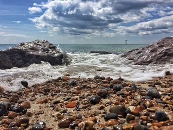 Scenic view of sea against cloudy sky