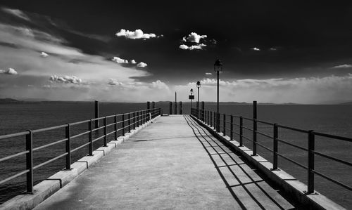 Pier on sea against sky