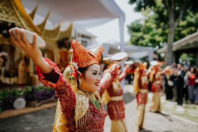 Midsection of woman dancing on street