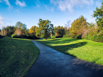 Scenic view of golf course against sky