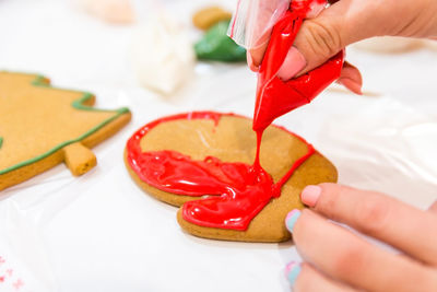 Midsection of woman holding red chili