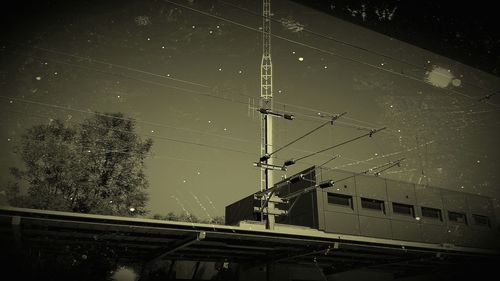 Low angle view of overhead cable car against sky