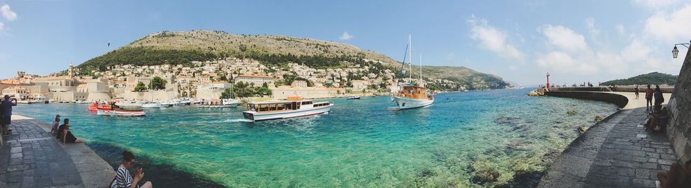 Panoramic view of sea and city against sky