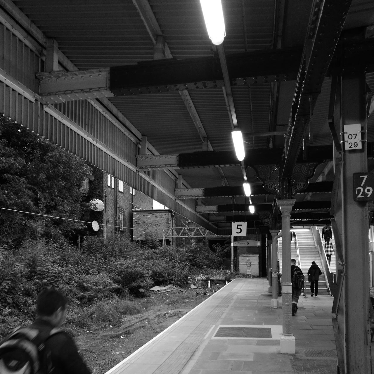 architecture, illuminated, built structure, walking, men, ceiling, person, full length, group of people, the way forward, city life, long, narrow, stairs, electric light, footpath, subway station, pedestrian walkway