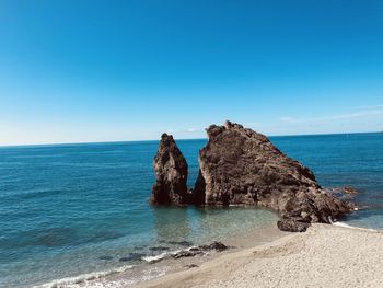 Scenic view of sea against clear blue sky