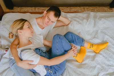 High angle view of mother and daughter on bed at home