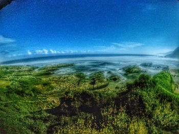 Scenic view of landscape against blue sky