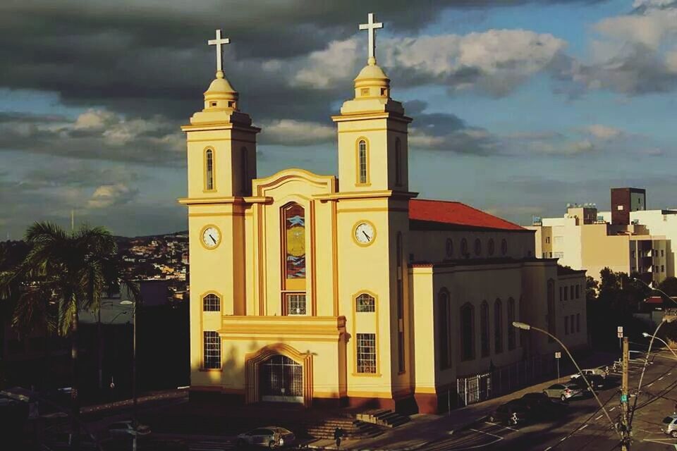 building exterior, architecture, church, built structure, religion, place of worship, sky, spirituality, cloud - sky, tree, cathedral, low angle view, tower, cloud, dome, sunset, facade, outdoors