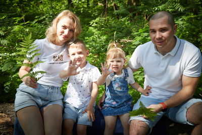 Portrait of friends sitting on field