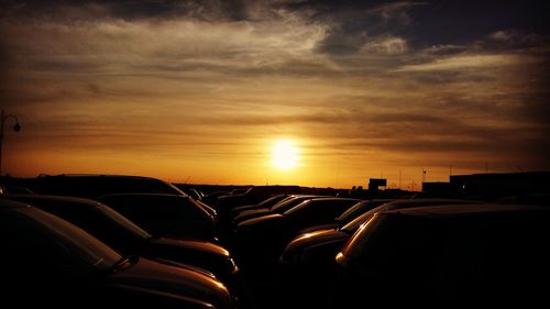 Cars on road at sunset