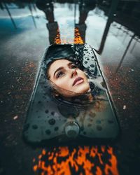 Portrait of a beautiful young woman in rain