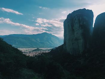 Scenic view of mountains against cloudy sky