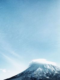 Low angle view of snow covered mountain against sky