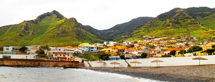 High angle view of townscape and mountains against sky