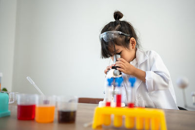 Female scientist examining chemical in laboratory