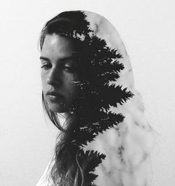 Double exposure of young woman and forest