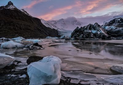 Scenic view of snowcapped mountains against sky during sunset